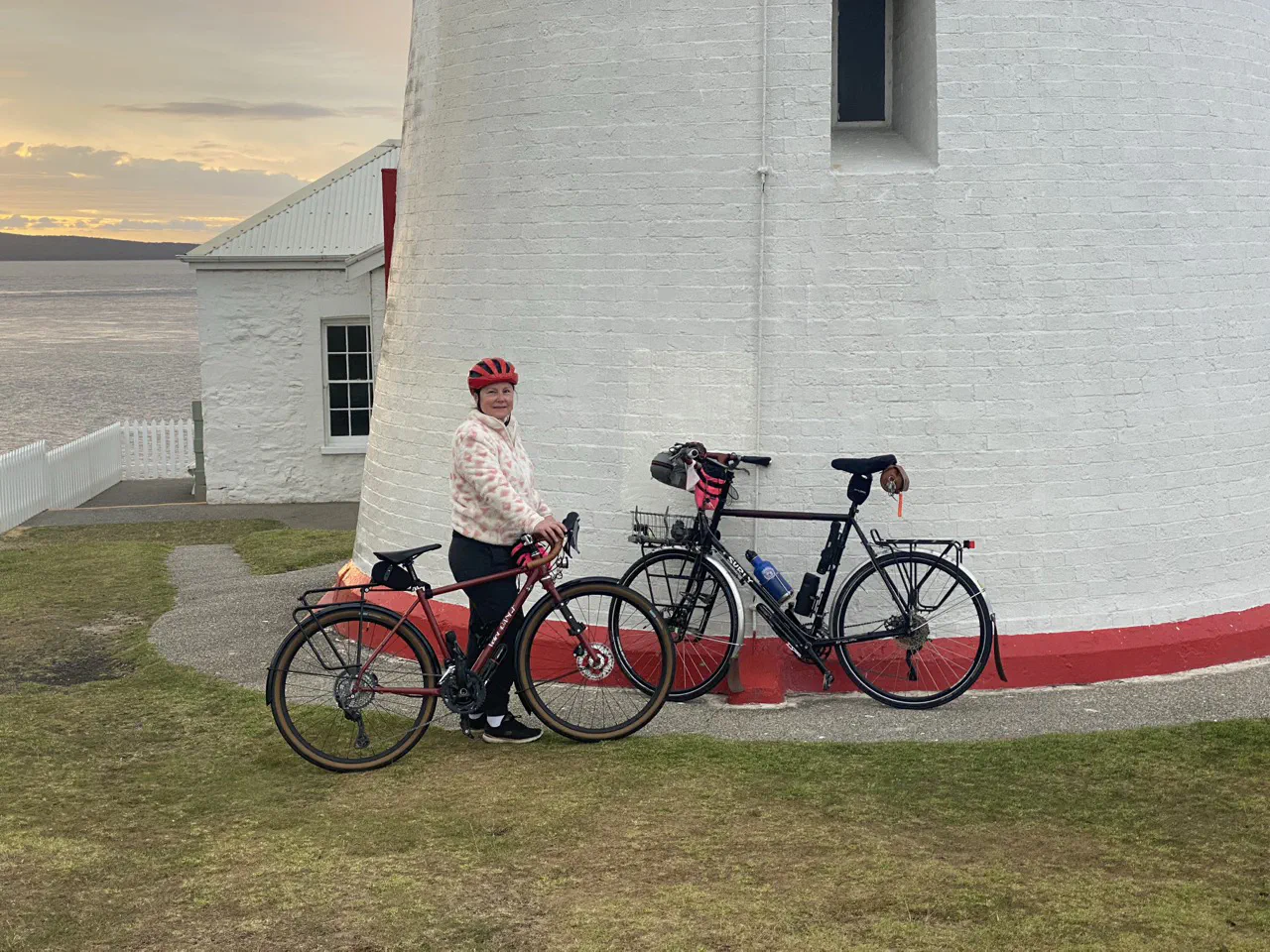 Our bikes resting against the Low Head Lighthouse