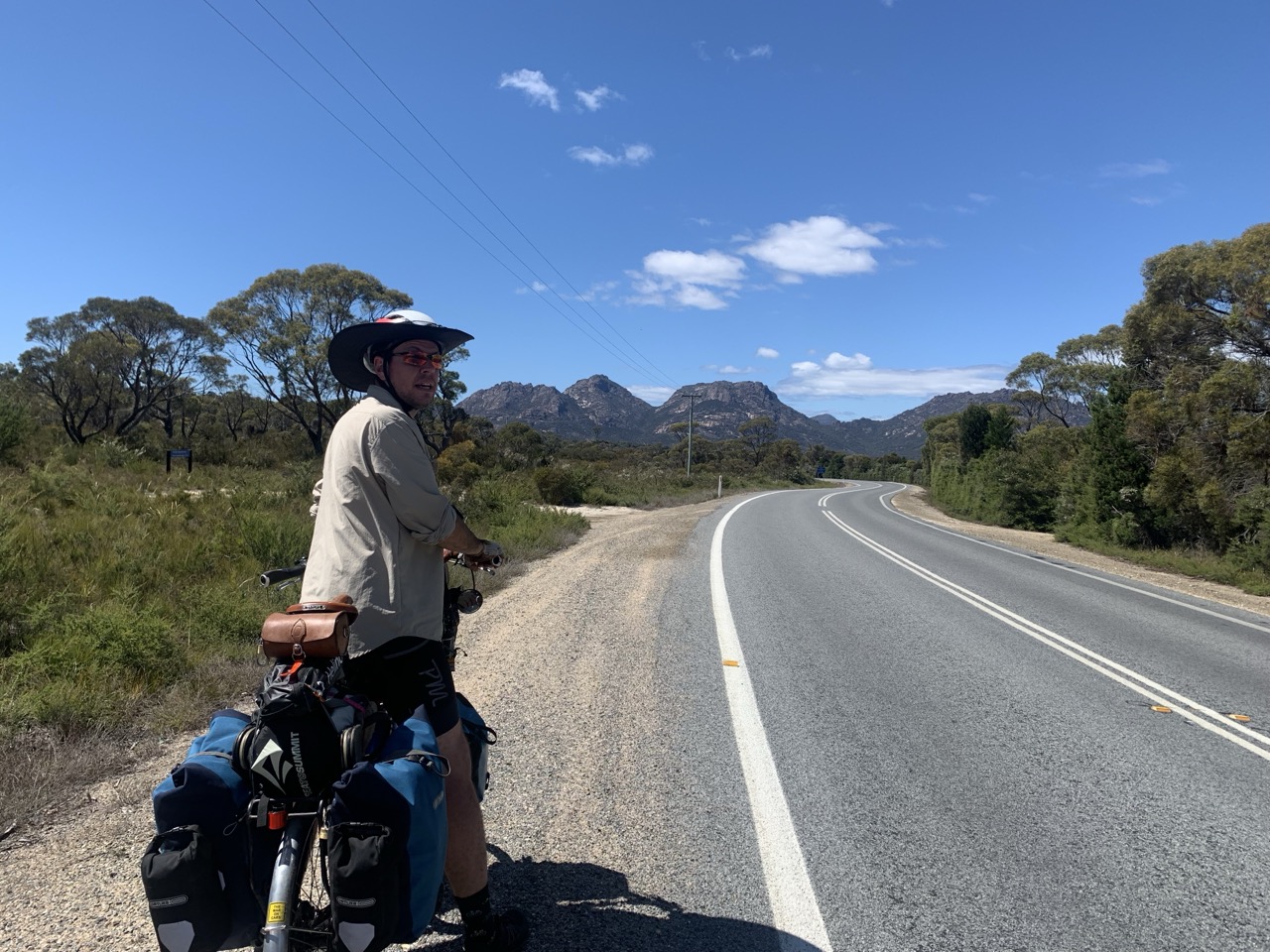 Stopping for a breather on Coles Bay Road, looking out at the scrubby coastal bush.